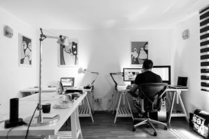 Photo d'une personne dans un milieu de travail bureautique, avec un siège ergonomique, en noir et blanc